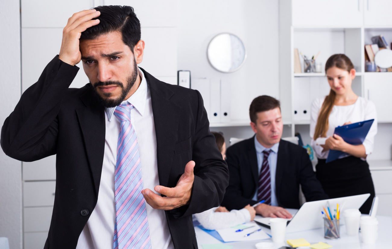 Photo of a man and other people in an office