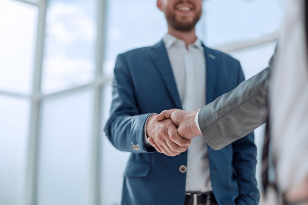 Man shaking hands with another person