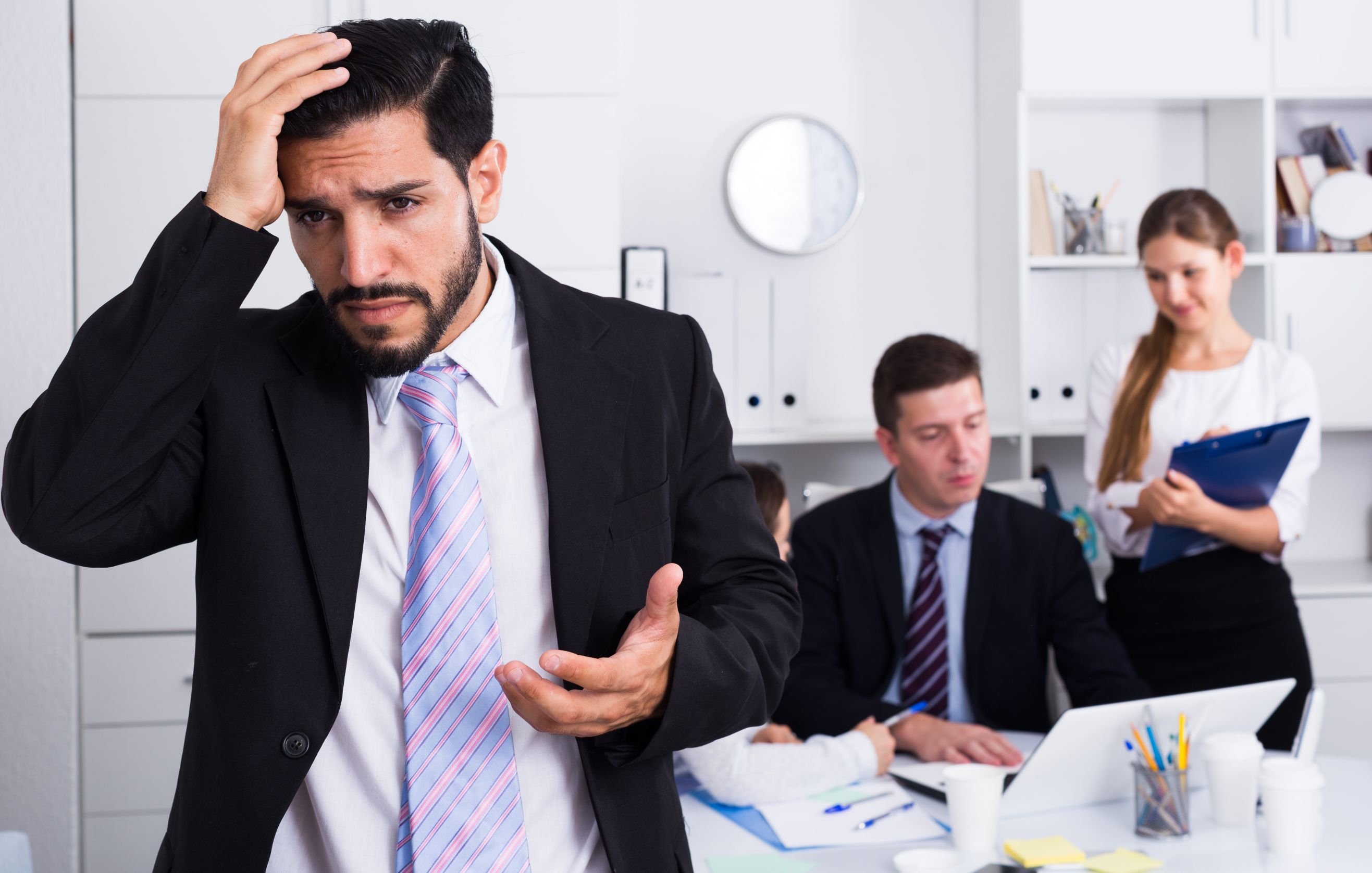 Photo of a man and other people in an office